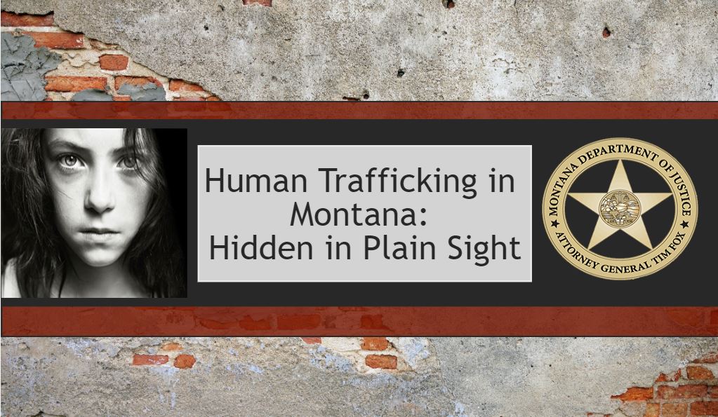 Poster reading 'Human Trafficking in Montana: Hidden in Plain Sight' on a brick wall